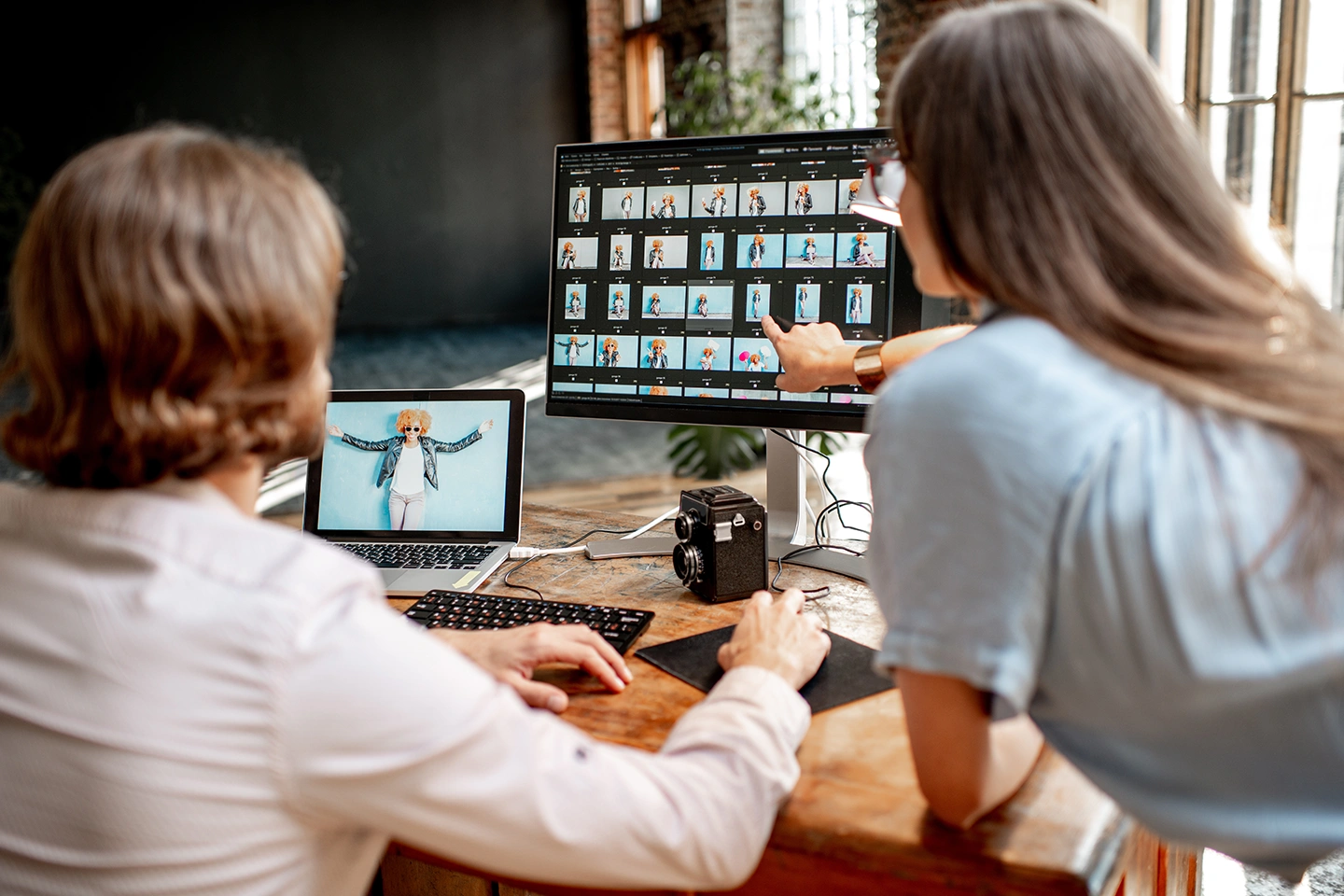 Two photographers reviewing and selecting photos